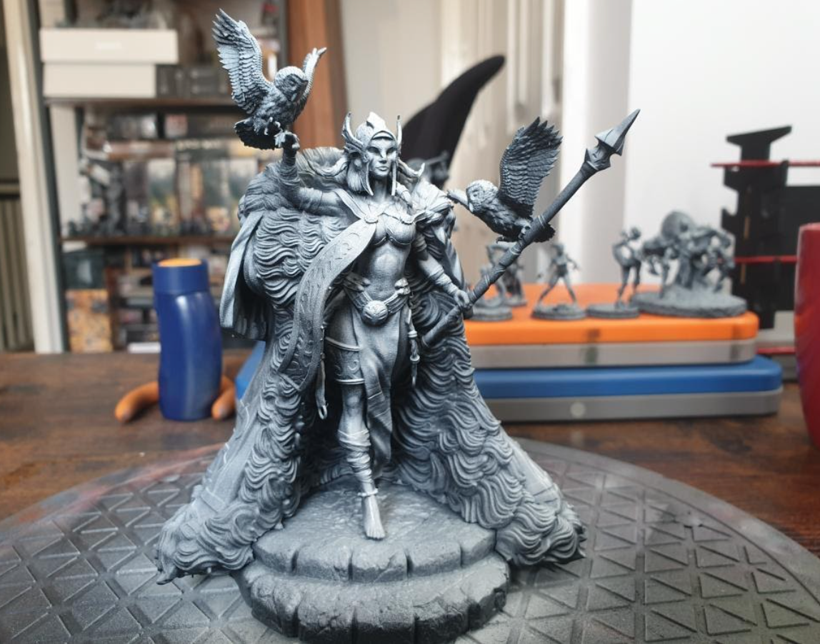 Zenithal prime the model by spraying with white primer above the black primer.