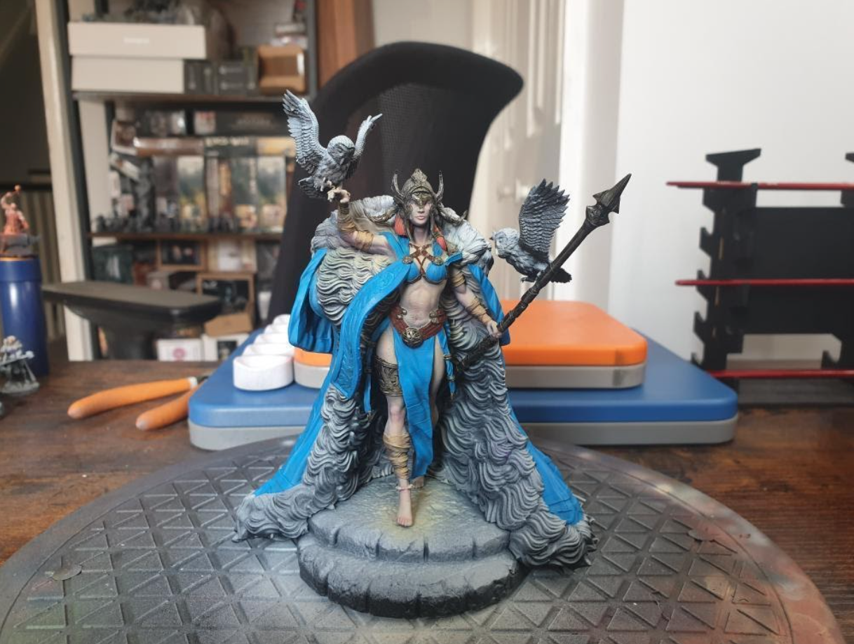 I used a blue airbrush paint to basecoat the cloak for a cold and regal theme.